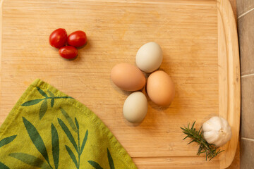 Fresh eggs with ingredients overhead kitchen counter