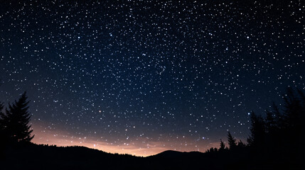 A breathtaking view of the starry night sky over a distant mountain range with a subtle glow on the horizon  
