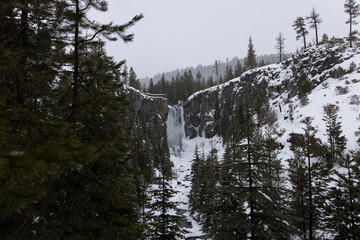 Oregon waterfall in the forest, winter landscape, snowshoeing, hiking or skiing