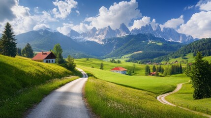 Scenic rural landscape featuring vibrant green fields, winding paths, and majestic mountain peaks under a clear blue sky.