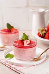 Strawberry panna cotta made with roasted strawberries, delicious, creamy dessert served with sauce and fresh berries. Homemade.