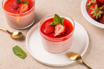 Couple of dessert, Strawberry panna cotta made with roasted strawberries, delicious, creamy dessert served with sauce and fresh berries. Homemade.