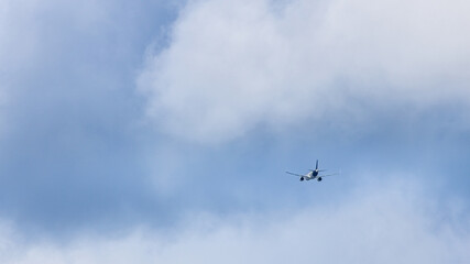 A plane is flying through a cloudy sky