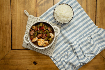 Cajun shrimp and sausage gumbo with rice on a wooden table