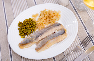 Lightly salted herring fillet with pickled cabbage and green peas