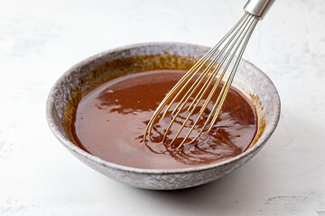 bowl of homemade hoisin sauce on white kitchen table