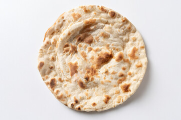 Naan bread traditional Indian flat bread made from flour, water, yeast and with yogurt, seen up close and from above isolated on white background 