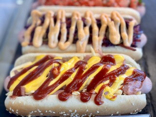 A tantalizing and tempting array of hot dogs, each topped with a delightful variety of delicious...