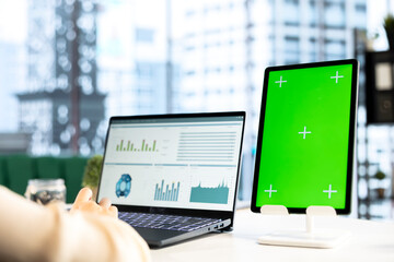 Woman company leader looking at isolated chroma key display in high end urban office, ambitious...