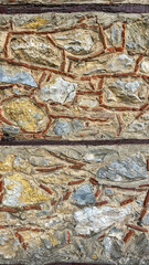 Close-Up Of A Rustic Stone Wall With Exposed Brick Details. Textured Surface Showcasing Natural Rock And Masonry Elements. Concept Of Architecture, Heritage, And Traditional Construction Techniques.