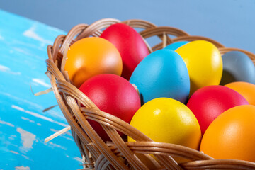 easter basket with straw and colored eggs