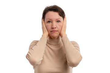 A woman with a neutral expression covering her ears with her hands against a white background.