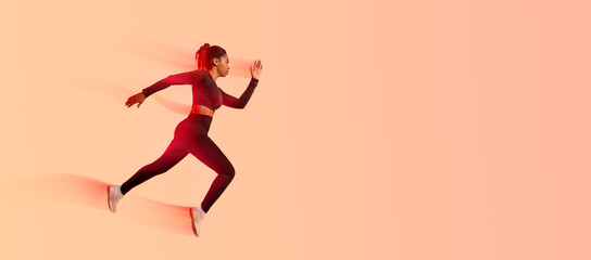 African american professional woman athlete, runner training isolated on neon colored studio...