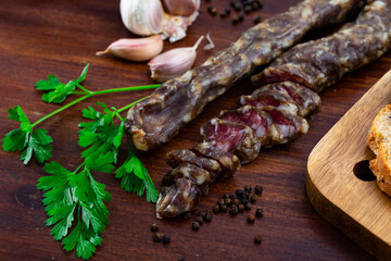 Traditional Spanish cured pork sausage with garlic, peppercorns and a sprig of fresh parsley on a...