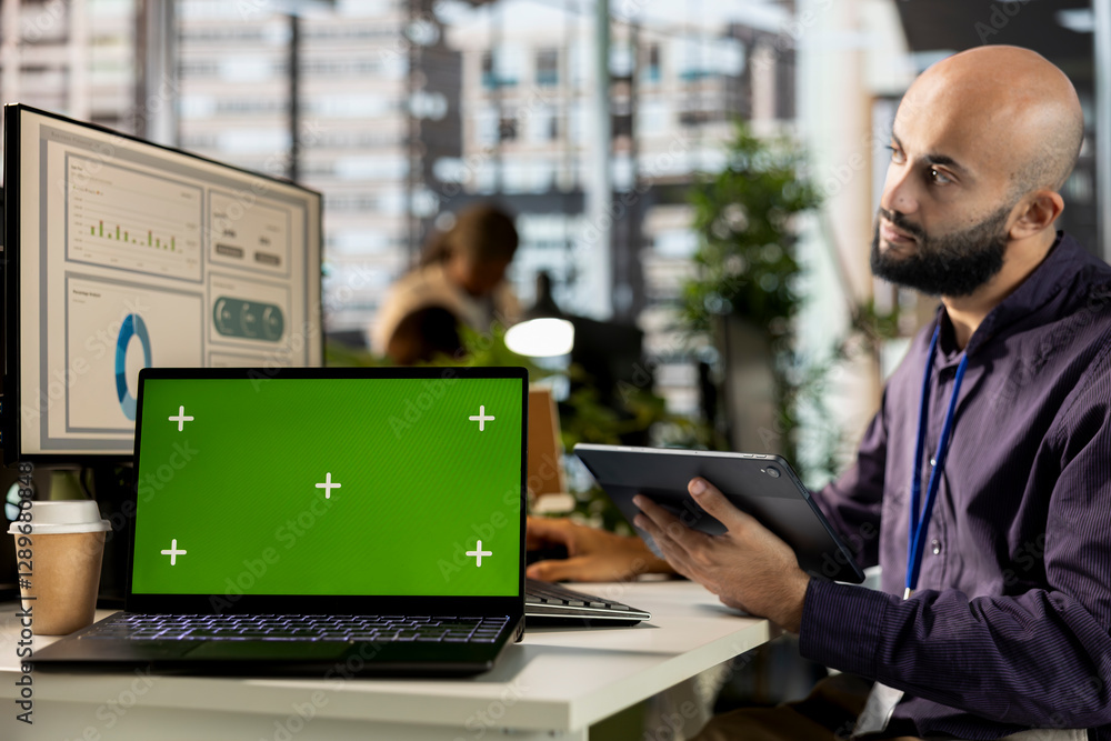 Poster professional analyst engages in project management next to chroma key display, working on global exp