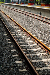 Image of railway tracks extending into the distance, showing a perspective view of the railway infrastructure. Train Tracks Extending into the Distance