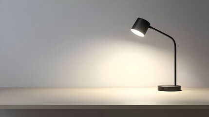 Black Desk Lamp Illuminating a Beige Table Against a White Wall