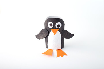 stage of a craft project using a cardboard toilet paper roll to create a penguin. simple and creative way to recycle materials into a fun and educational craft project. activity for kids and parernts