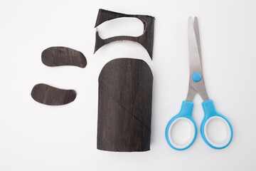 Craft project stages with cardboard toilet paper roll to create a penguin. Great for DIY enthusiasts, and educational materials focusing on creative recycling and hands-on learning. creative process