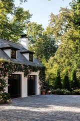 Fototapeta premium Elegant home exterior with manicured garden and cobblestone driveway in a serene suburban neighborhood during a sunny day
