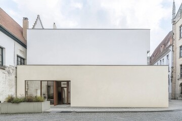 Modern architectural structure featuring minimalistic design located in an urban setting with cobblestone streets showcasing a blend of contemporary and traditional elements