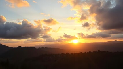 Fototapeta premium Sunset Over a Village in the Mountains with Warm Light and Cloudy Skies