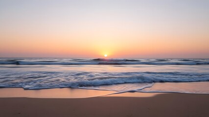  Sunset on the Horizon with Gentle Waves and Clear Skies Over a Quiet Beach