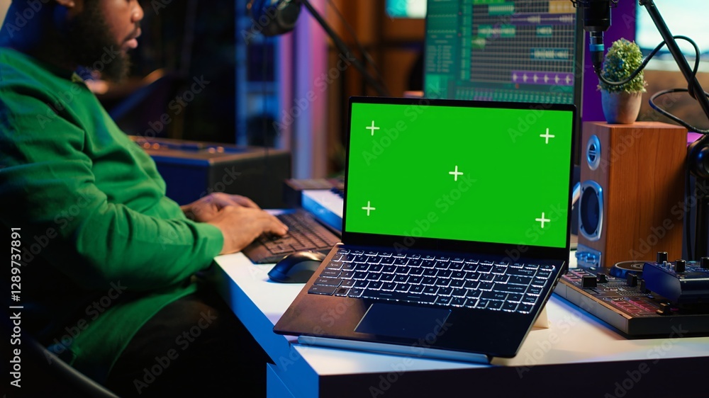 Poster Professional artist operating on daw software in home studio, using a green screen layout next to him. Producer editing his audio recordings by applying mixing and mastering techniques. Camera A.