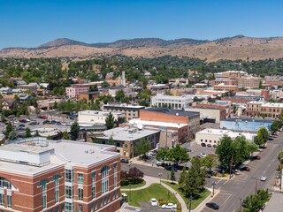 High-angle view of Klamath Falls town center, showcasing diverse architecture and ample parking....