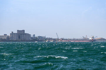 Rippling turquoise waters and strong wave currents on a windy day at Geelong's waterfront, with...