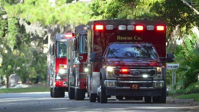 First responders investigating fire hazard of private house. Emergency service personnel responding to carbon monoxide accident on Florida residential street.