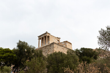 Temple of Athena Nike in prominent position on a steep bastion of Acropolis. Ancient building dedicated to goddesses Athena and Nike. Athens,Greece
