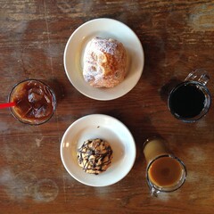 iced coffee and pastries on a table at a coffee shop
