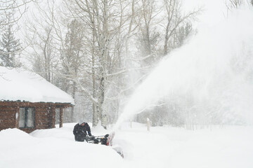 Clearing sidewalk during snowstorm; Grand Teton NP; Wyoming