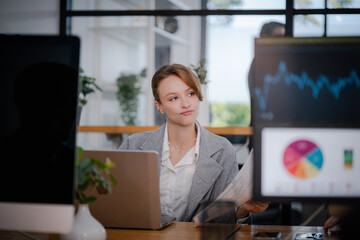 Businesswoman sitting and analyzing business performance in office