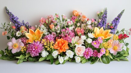 A stunning display of colorful spring flowers arranged on a light paper backdrop, highlighting the beauty and freshness of nature.