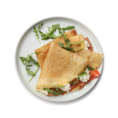 Delicious crepes with salmon, cream cheese and arugula isolated on white, top view