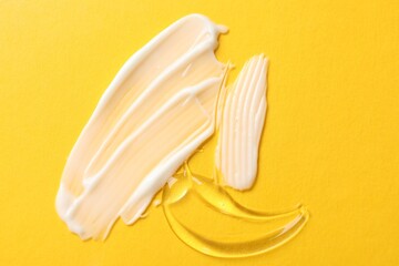 Samples of different cosmetic products on yellow background, flat lay
