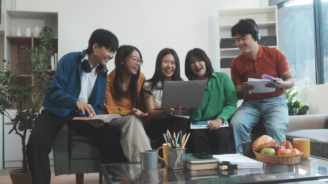 Five young Asian students engage in online study on campus, collaborating on research, projects. They help each other with assignments, gaining valuable experience and preparing for future careers.