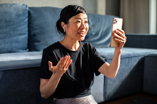 Woman tracking workout progress on fitness app after exercise