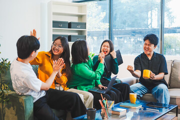 Fototapeta premium Five young Asian students engage in online study on campus, collaborating on research, projects. They help each other with assignments, gaining valuable experience and preparing for future careers.