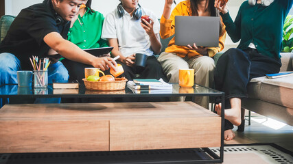 Five young Asian students engage in online study on campus, collaborating on research, projects....