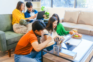 Five young Asian students engage in online study on campus, collaborating on research, projects. They help each other with assignments, gaining valuable experience and preparing for future careers.