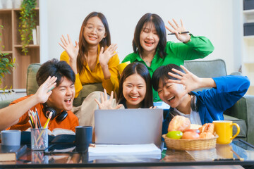Five young Asian students engage in online study on campus, collaborating on research, projects. They help each other with assignments, gaining valuable experience and preparing for future careers.