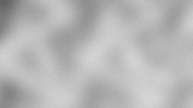An abstract neutral black and white mottled grainy grunge texture motion graphic background loop design.