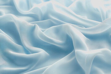 Obraz premium Blue silk fabric draped elegantly on a surface showcasing its smooth texture and vibrant color