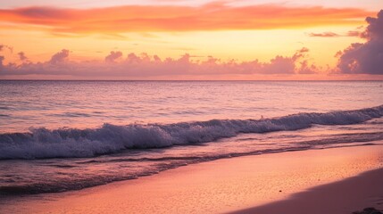 Caribbean sunset with orange and pink hues, calm waves, and a clean horizon, evoking serenity and natural beauty.
