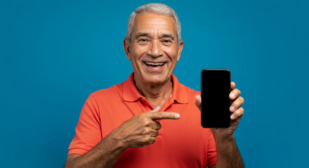 Eldery man pointing to smartphone and smiling