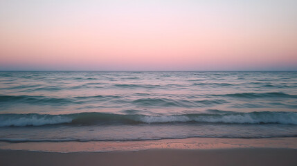 Obraz premium serene beach scene with soft waves lapping at shore during sunset, creating tranquil atmosphere. pastel colors of sky reflect on water surface, enhancing peaceful vibe