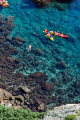 red coral reef and kayaks